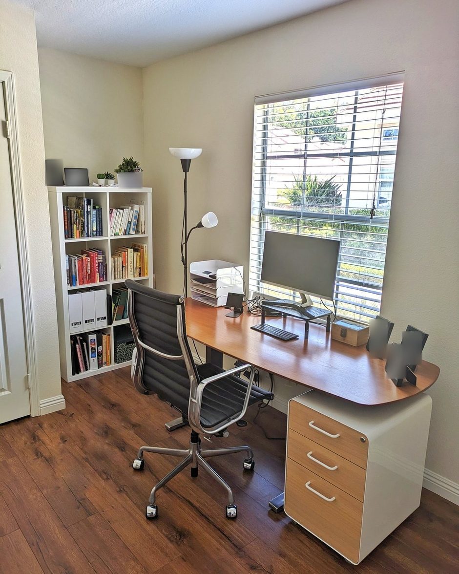 The same home office from the same corner after: clear desk, sorted shelf, letter trays