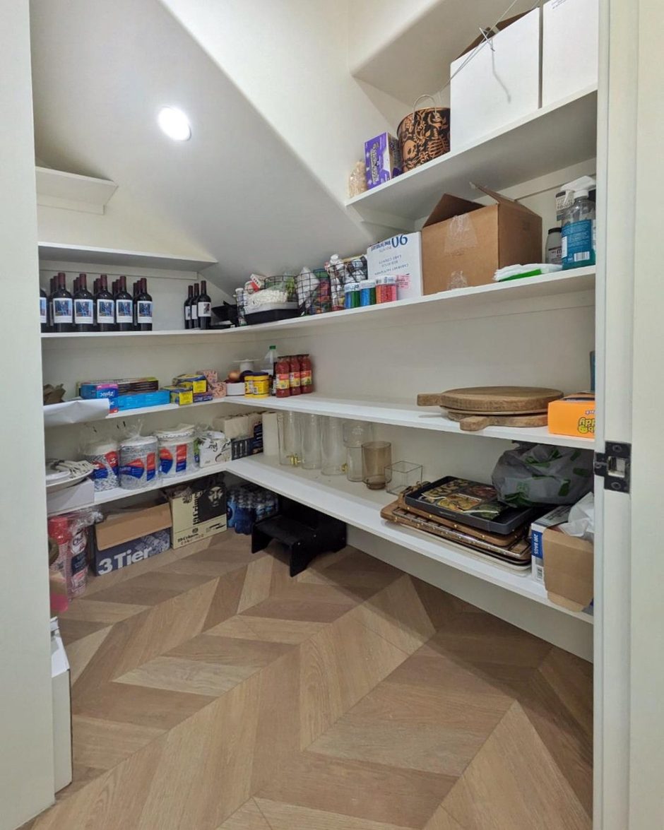 The walk-in pantry before: half-empty shelves with boxes and supplies piled at random